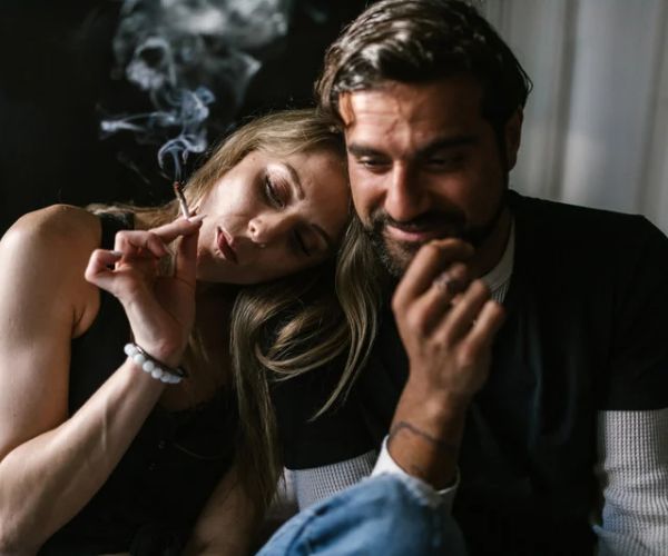 man and woman smoking CBD pre-roll joint